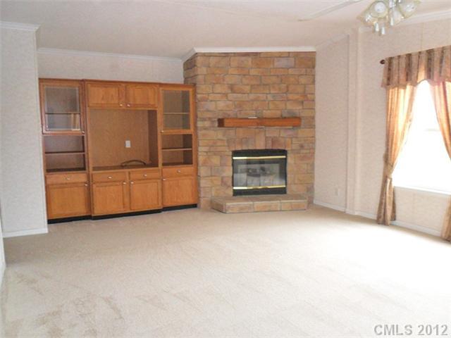 872 Tower Road Vale, NC 28168 - Photo 3 of 6 an empty room with furniture and a fireplace