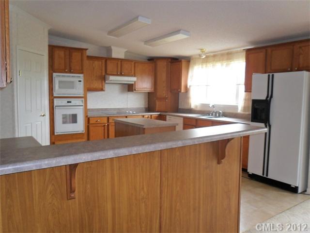 872 Tower Road Vale, NC 28168 - Photo 4 of 6 a kitchen with stainless steel appliances a refrigerator a sink a stove a microwave and island