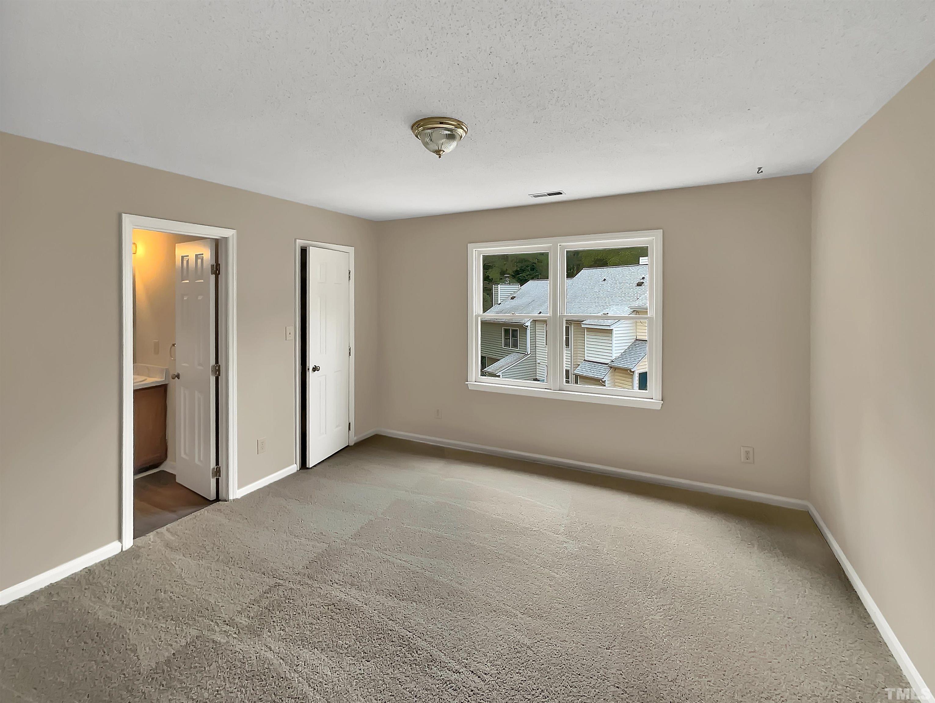 4101 Kaplan Drive Raleigh, NC 27606 - Photo 15 of 22 an empty room with windows and closet