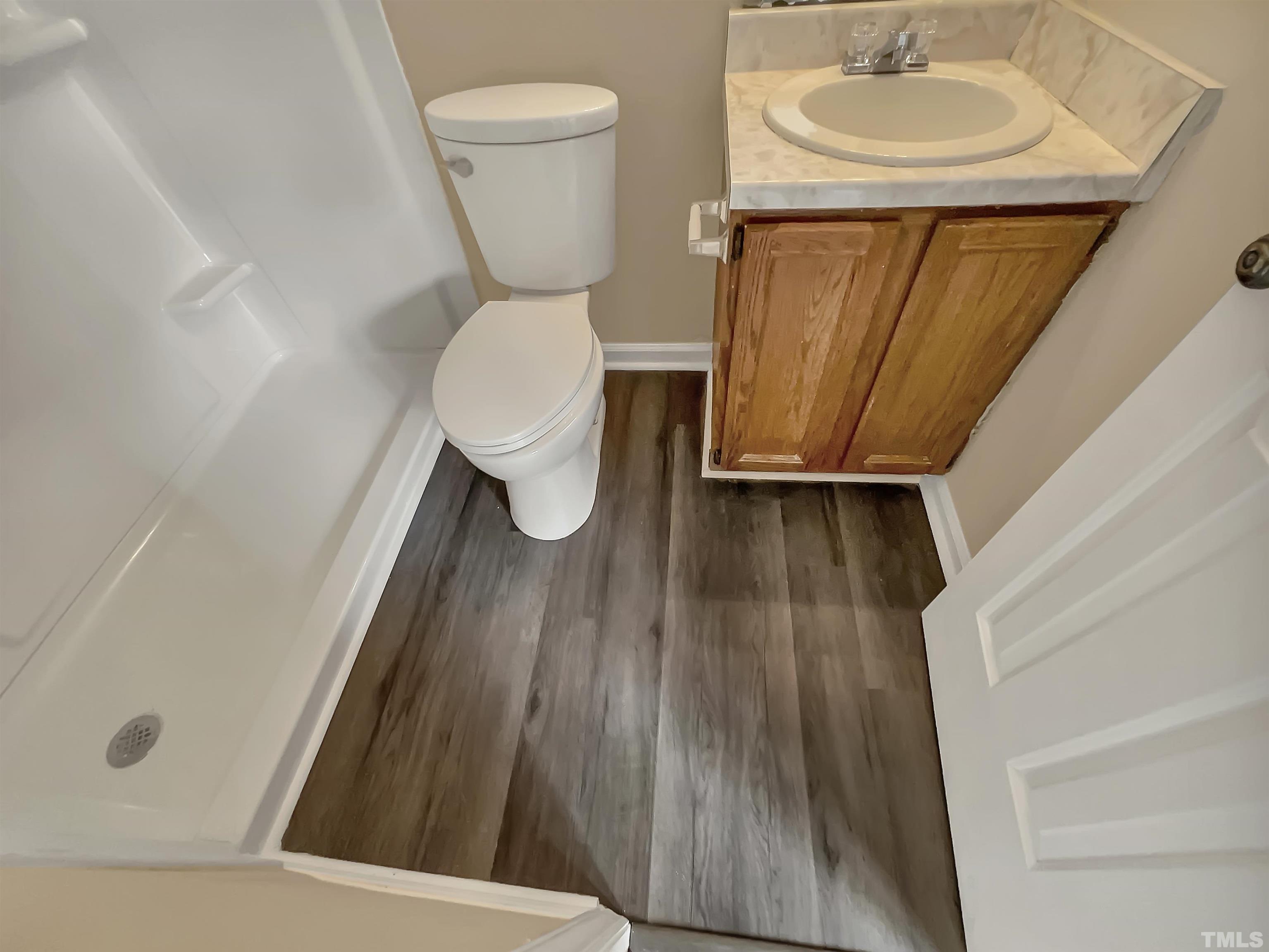 4101 Kaplan Drive Raleigh, NC 27606 - Photo 17 of 22 a bathroom with a sink a toilet and a mirror