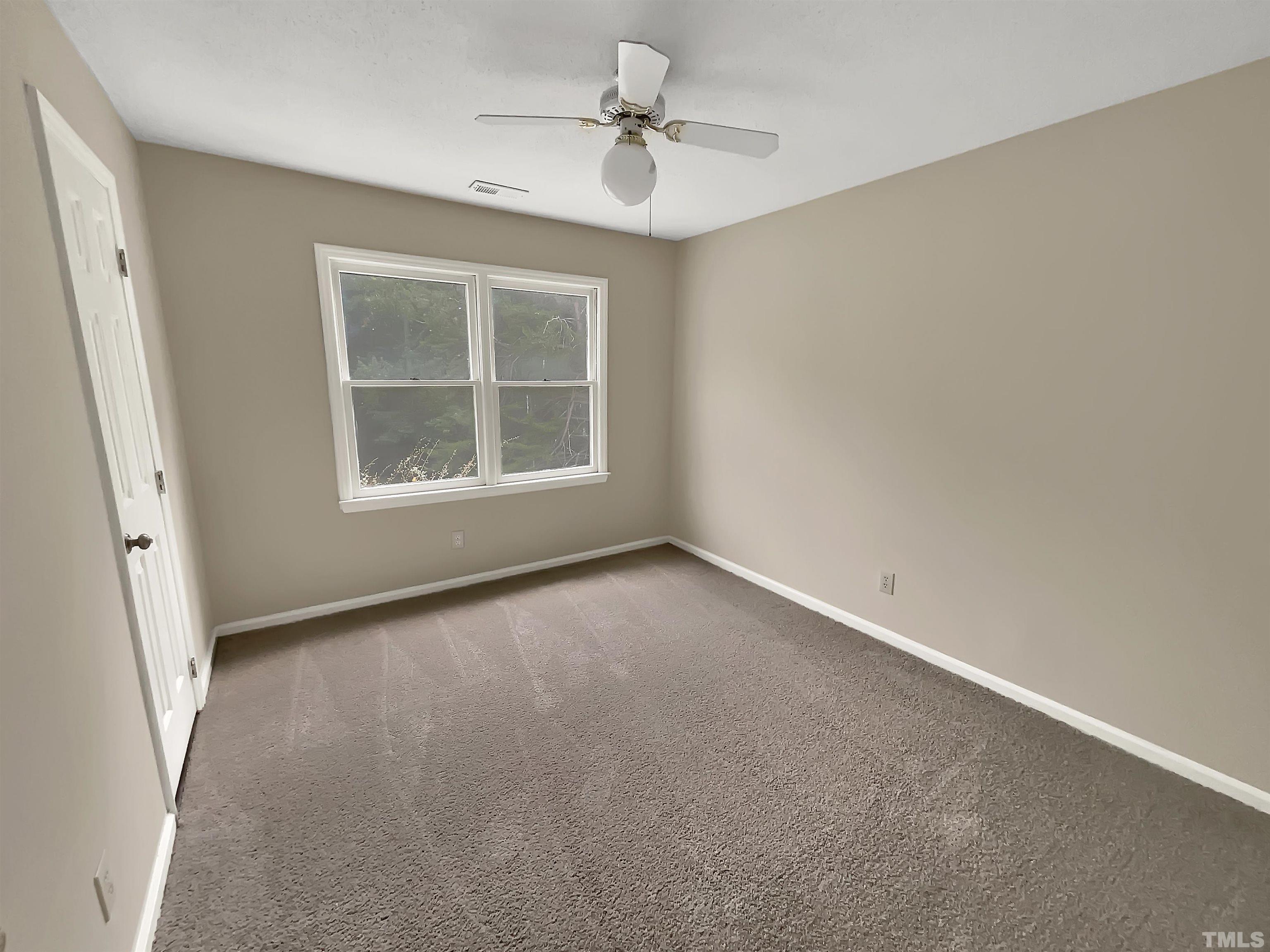 4101 Kaplan Drive Raleigh, NC 27606 - Photo 19 of 22 an empty room with a window and a ceiling fan