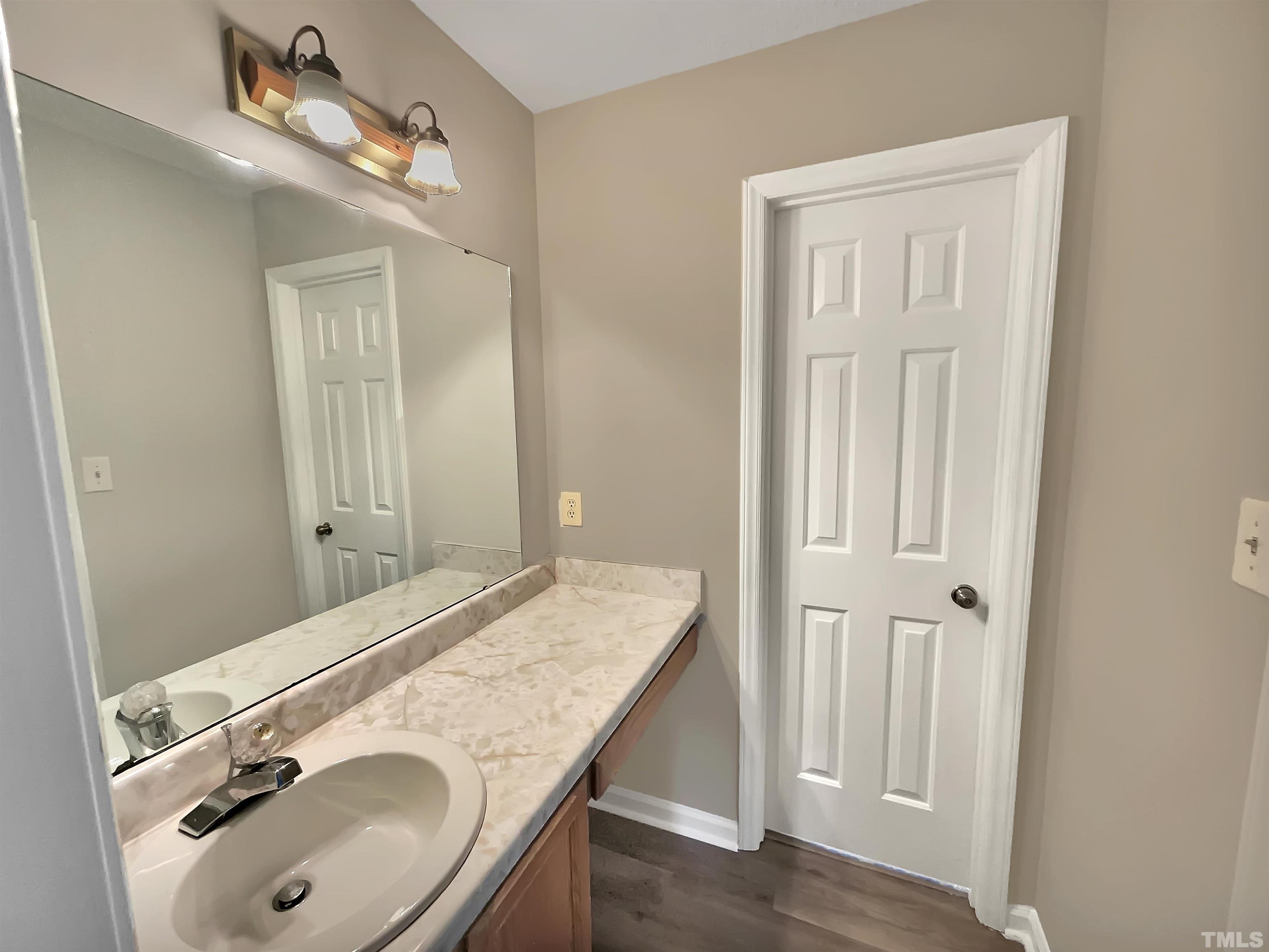 4101 Kaplan Drive Raleigh, NC 27606 - Photo 21 of 22 a bathroom with a sink vanity granite tub and mirror
