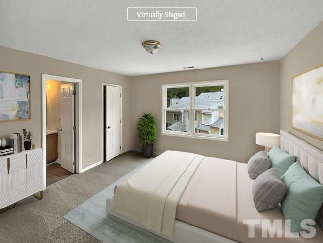4101 Kaplan Drive Raleigh, NC 27606 - Photo 3 of 22 a bedroom with a large bed and a window