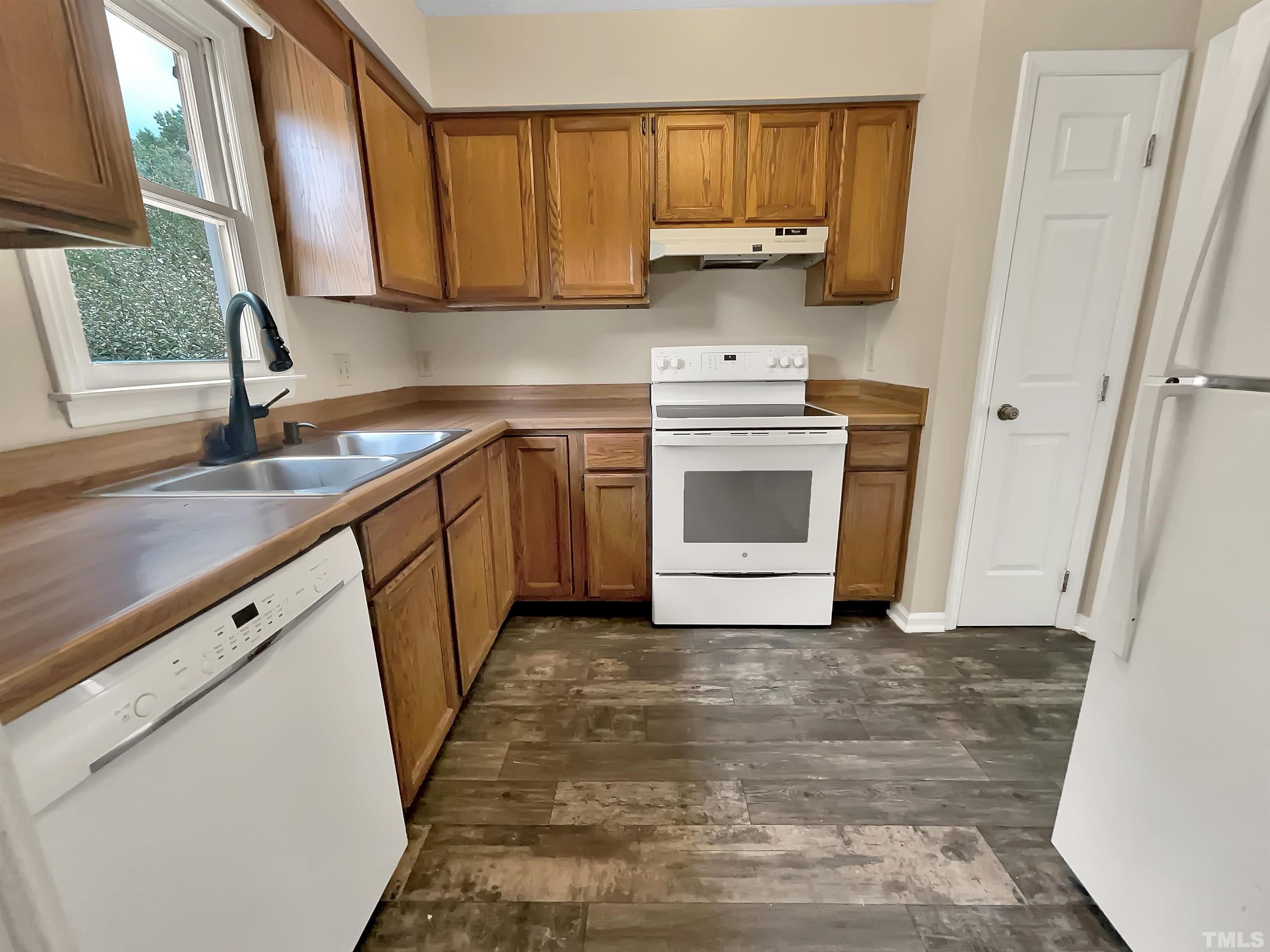 4101 Kaplan Drive Raleigh, NC 27606 - Photo 4 of 22 a kitchen with a sink stove and cabinets
