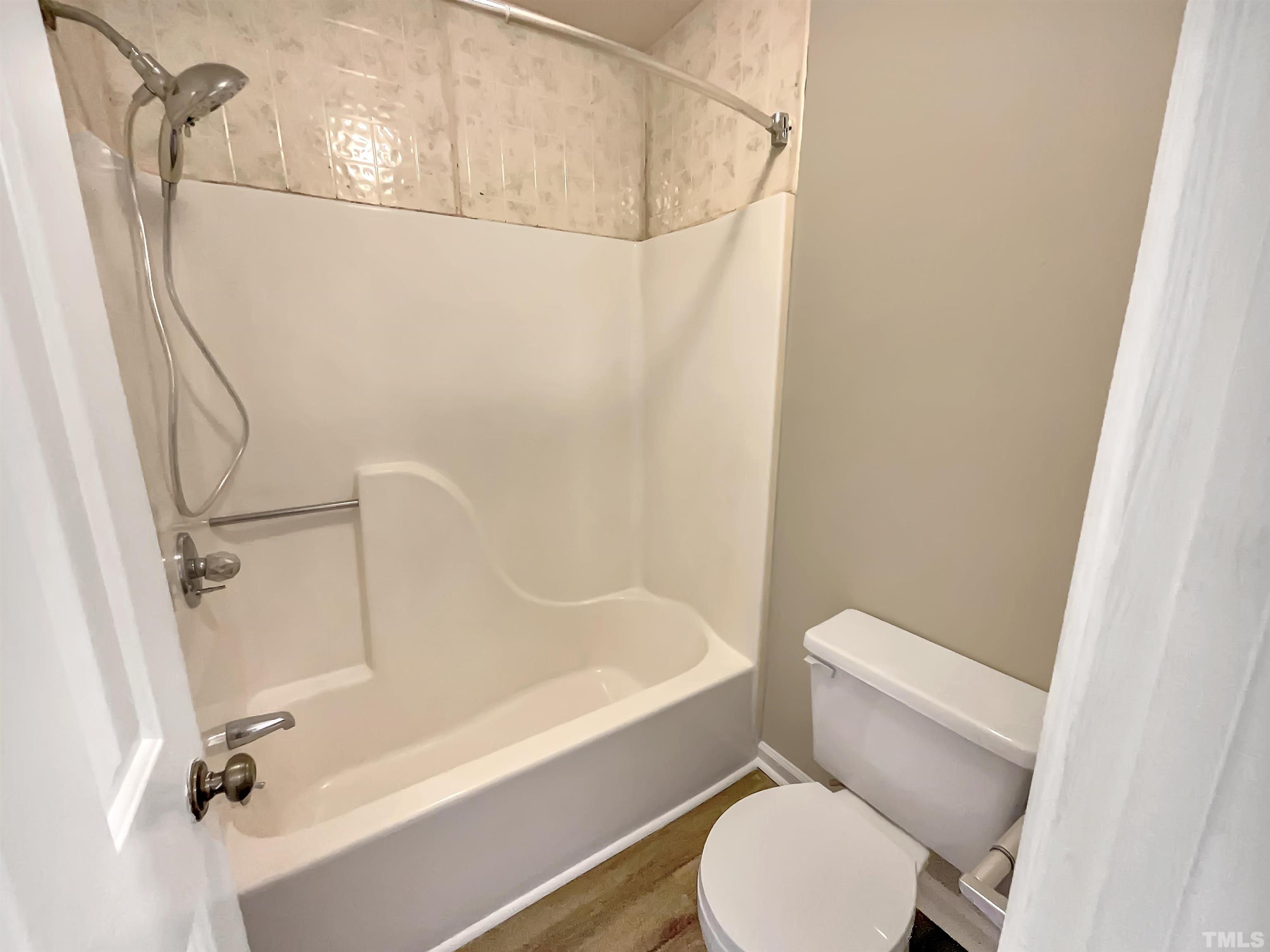 4101 Kaplan Drive Raleigh, NC 27606 - Photo 6 of 22 a white toilet sitting next to a bath tub
