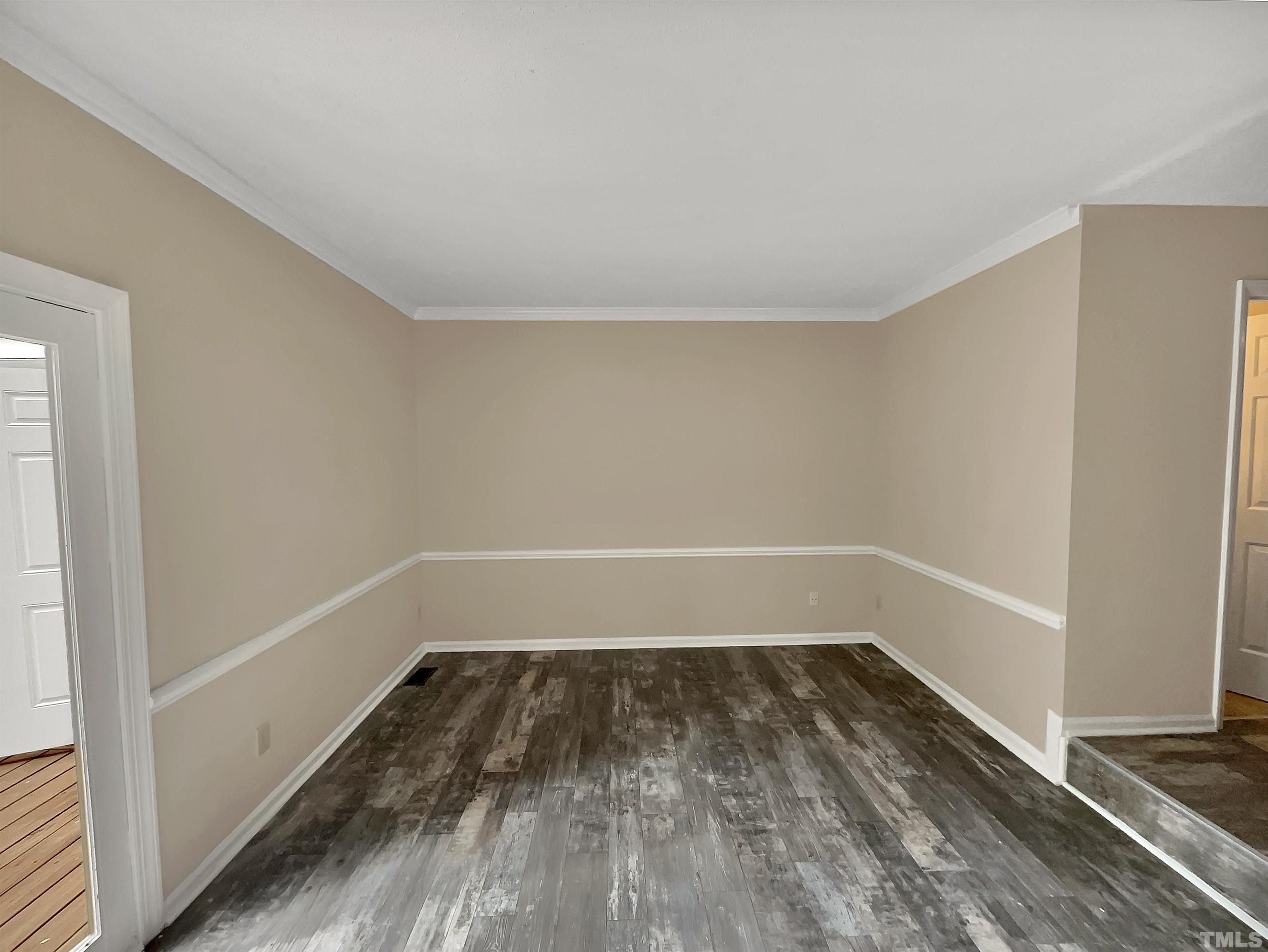 4101 Kaplan Drive Raleigh, NC 27606 - Photo 9 of 22 a view of a room with wooden floor and white walls