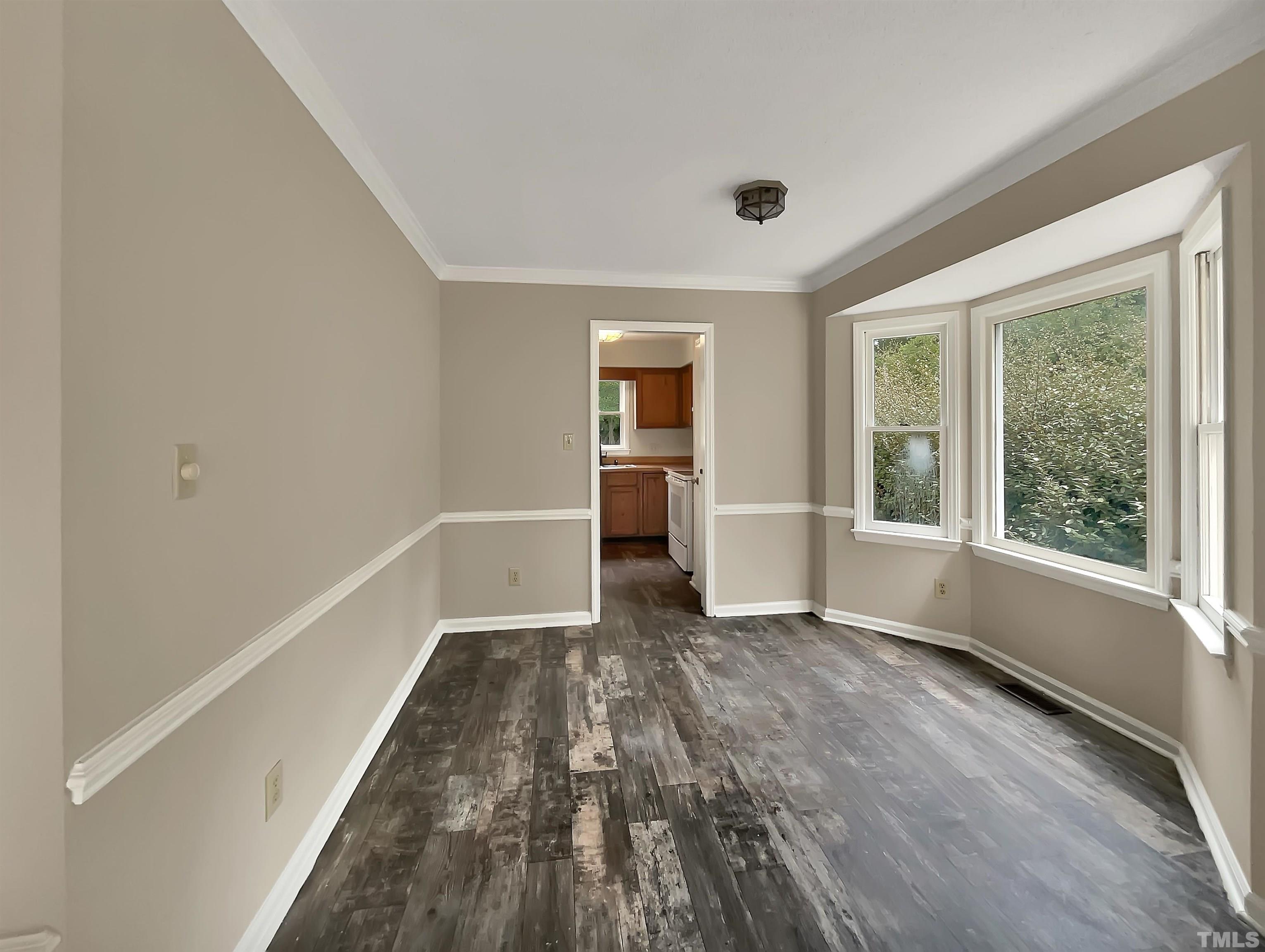 4101 Kaplan Drive Raleigh, NC 27606 - Photo 10 of 22 a view of an empty room with a window and wooden floor