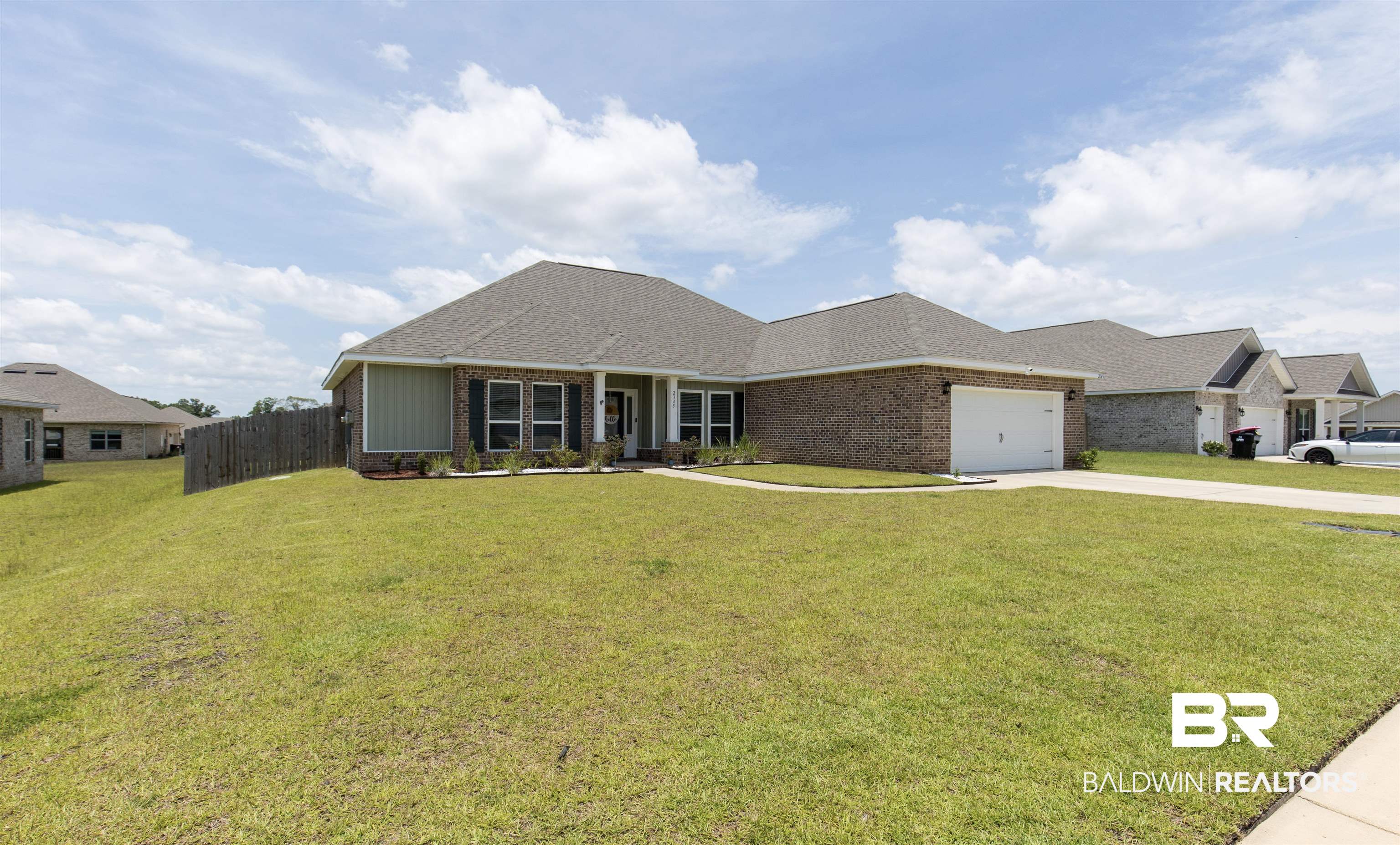 2345 Laurel Street Semmes, AL 36575 - Photo 29 of 31 View of front of property with driveway, an attached garage, brick siding, and a shingled roof