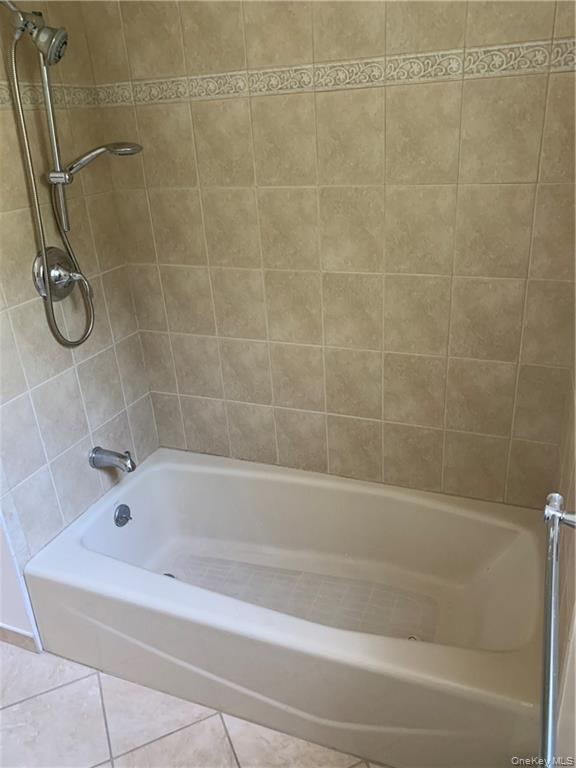 5 Ridge Road, Unit 2 Dobbs Ferry, NY 10522 - Photo 14 of 18 a bathroom with a bath tub with a shower