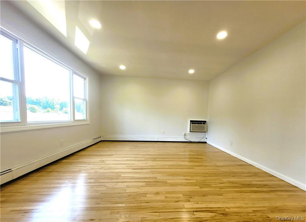 5 Ridge Road, Unit 2 Dobbs Ferry, NY 10522 - Photo 5 of 18 a view of an empty room with wooden floor and a window
