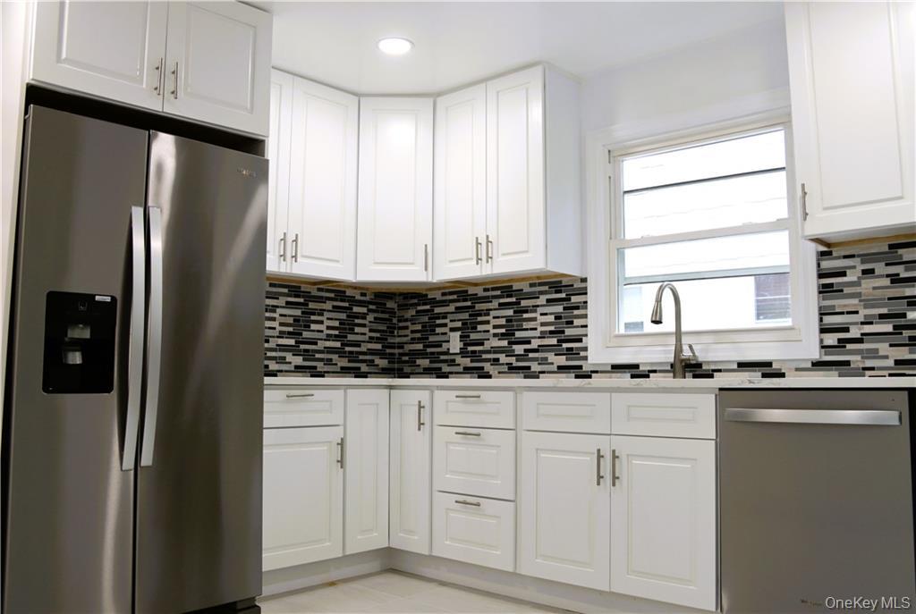 5 Ridge Road, Unit 2 Dobbs Ferry, NY 10522 - Photo 6 of 18 a kitchen with granite countertop white cabinets and refrigerator