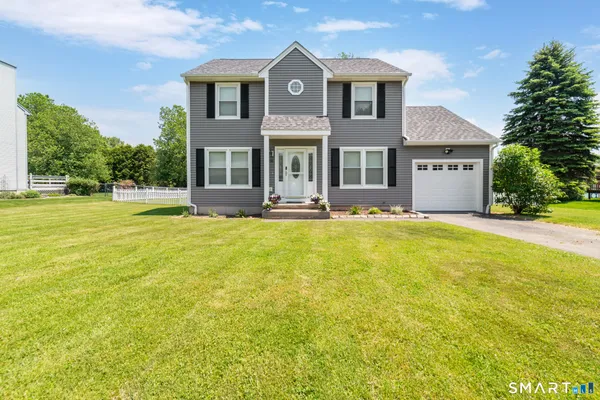 a front view of house with yard and green space