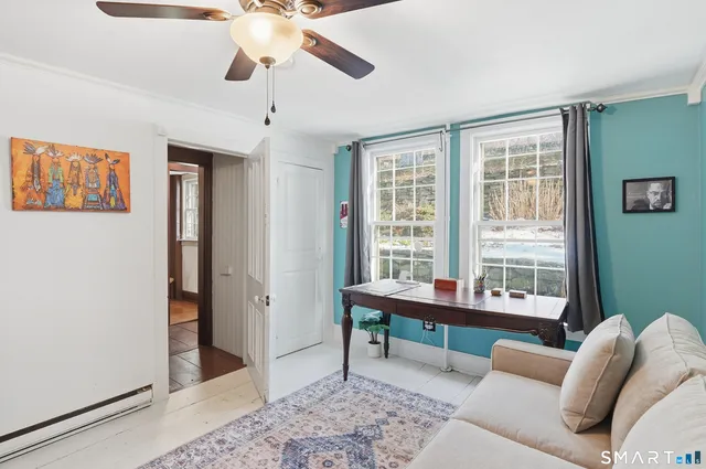 a reading room with furniture and a window