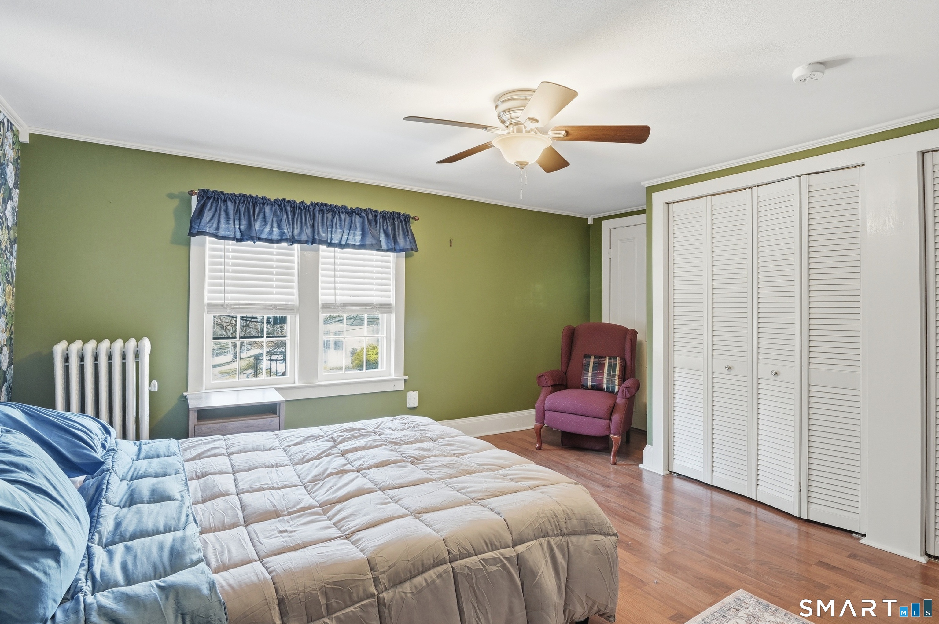 417 Washington Street Norwich, CT 06360 - Photo 20 of 40 a bedroom with a bed and a chandelier