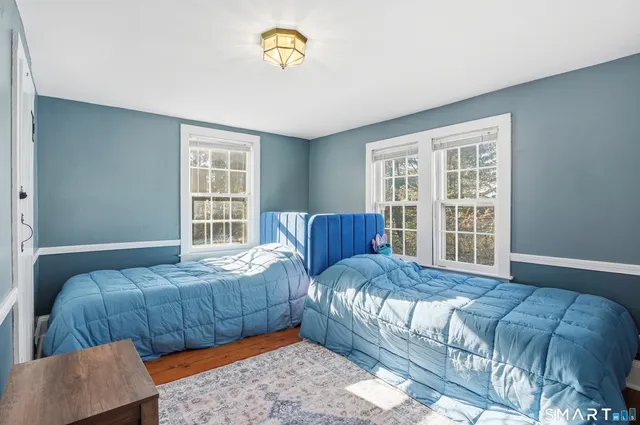 a bedroom with a large bed and a window