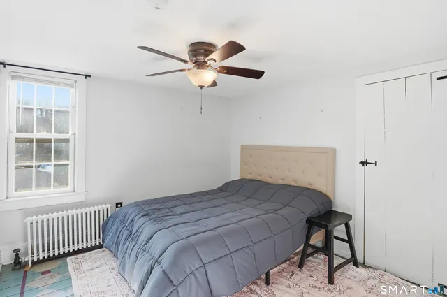 a bedroom with a bed and a window