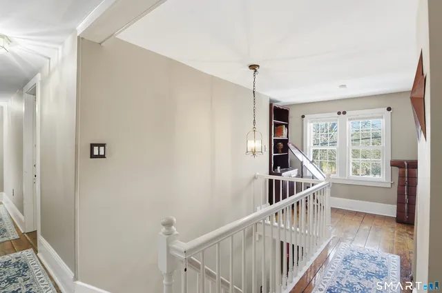 a view of entryway with wooden floor and windows