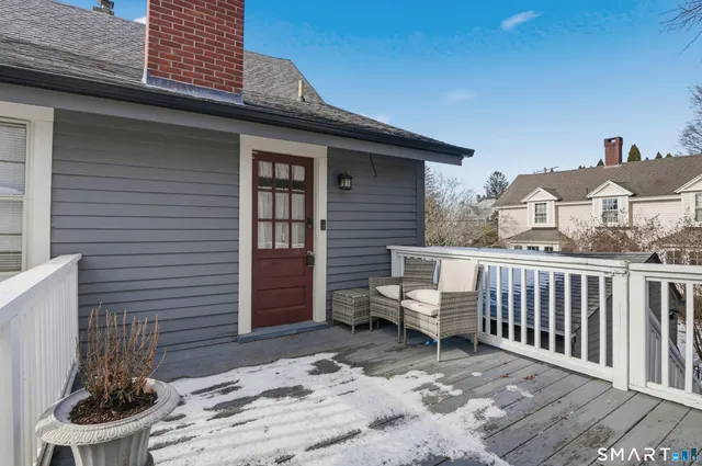 a view of a patio with a table and chairs and a barbeque