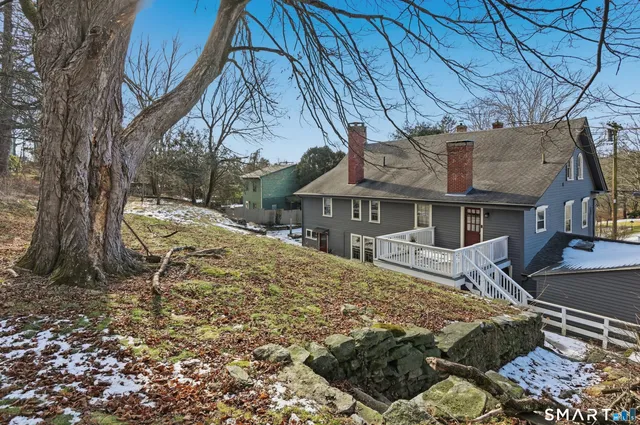 a view of a house with a snow in a yard