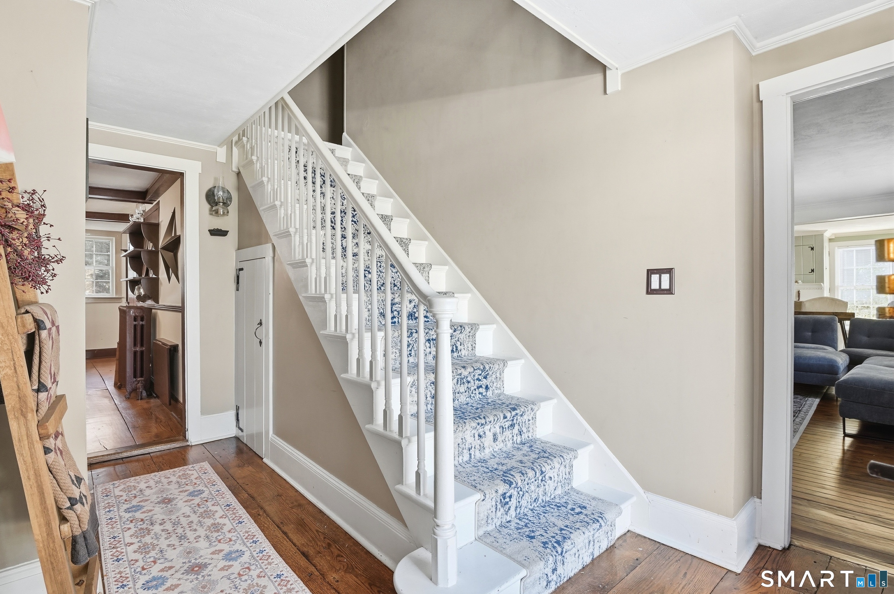 417 Washington Street Norwich, CT 06360 - Photo 5 of 40 a view of staircase with white walls and a rug