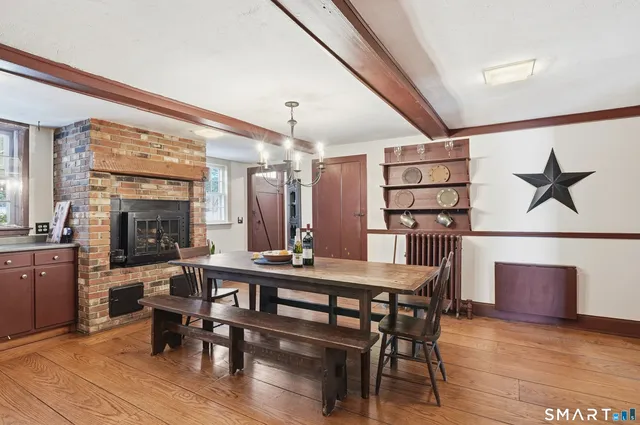 a view of a a dining room with furniture window and wooden floor