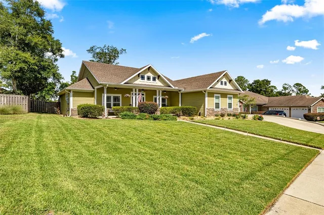 a front view of a house with a yard table and chairs
