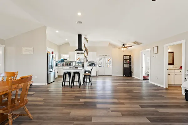 a bedroom with furniture and wooden floor