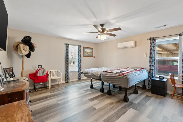 a bedroom with a bed and a chandelier