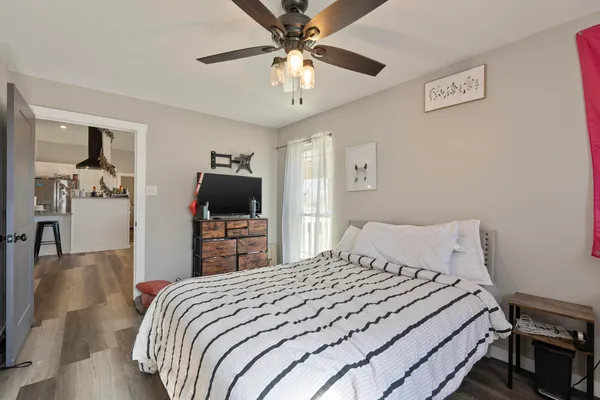 a bedroom with a bed and a chandelier