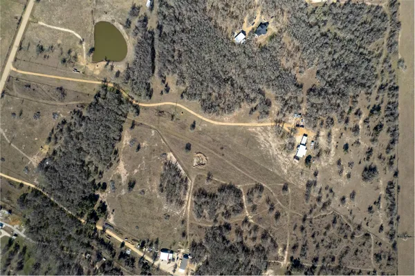 an aerial view of a house with a lake view
