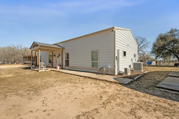 a kitchen with stainless steel appliances a dining table chairs stove and cabinets
