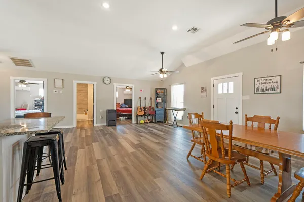 a kitchen with granite countertop kitchen island stainless steel appliances a sink and stove