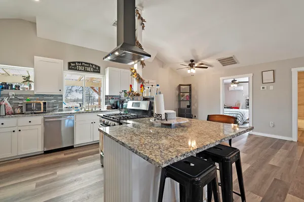 a kitchen with a stove a sink and a refrigerator