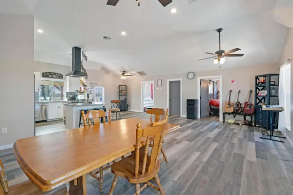 a dining room with furniture and wooden floor