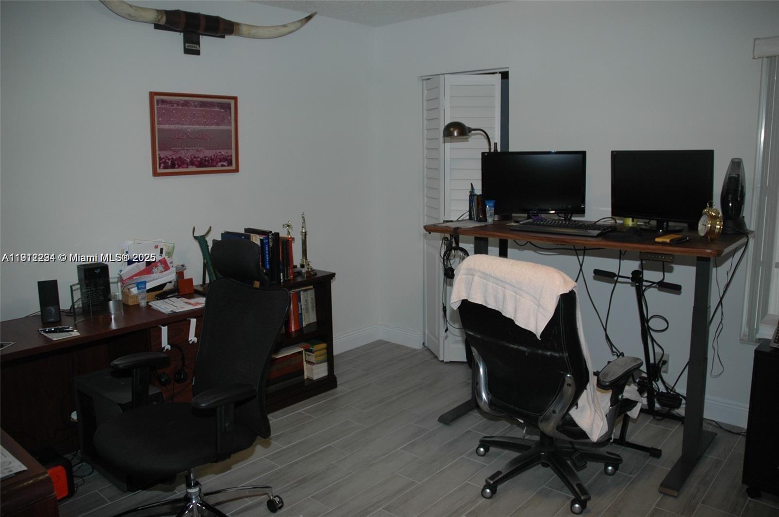 3571 Inverrary Drive, Unit 201 Lauderhill, FL 33319 - Photo 19 of 48 a view of a workspace with furniture and a flat screen tv