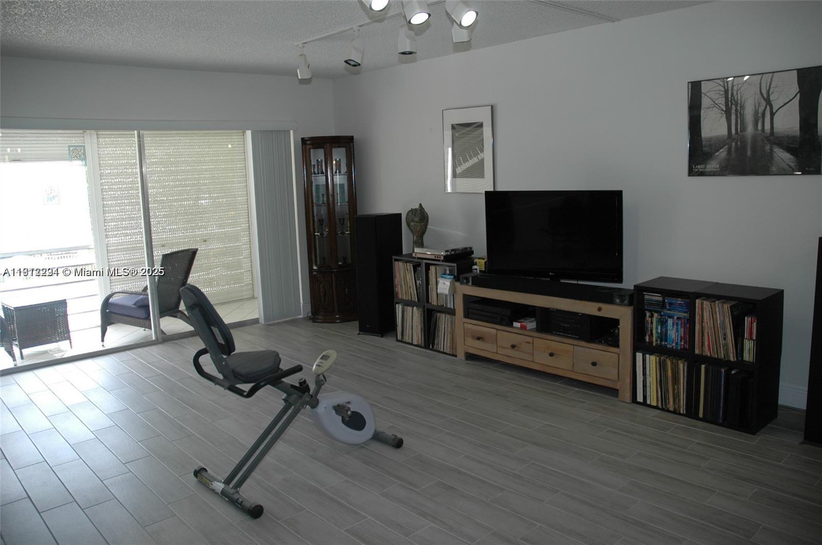 3571 Inverrary Drive, Unit 201 Lauderhill, FL 33319 - Photo 20 of 48 a room with furniture and wooden floor