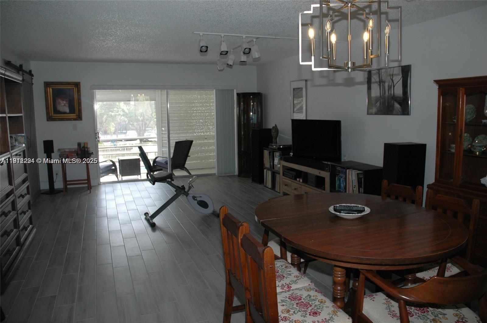 3571 Inverrary Drive, Unit 201 Lauderhill, FL 33319 - Photo 21 of 48 a view of a dining room with furniture window and wooden floor