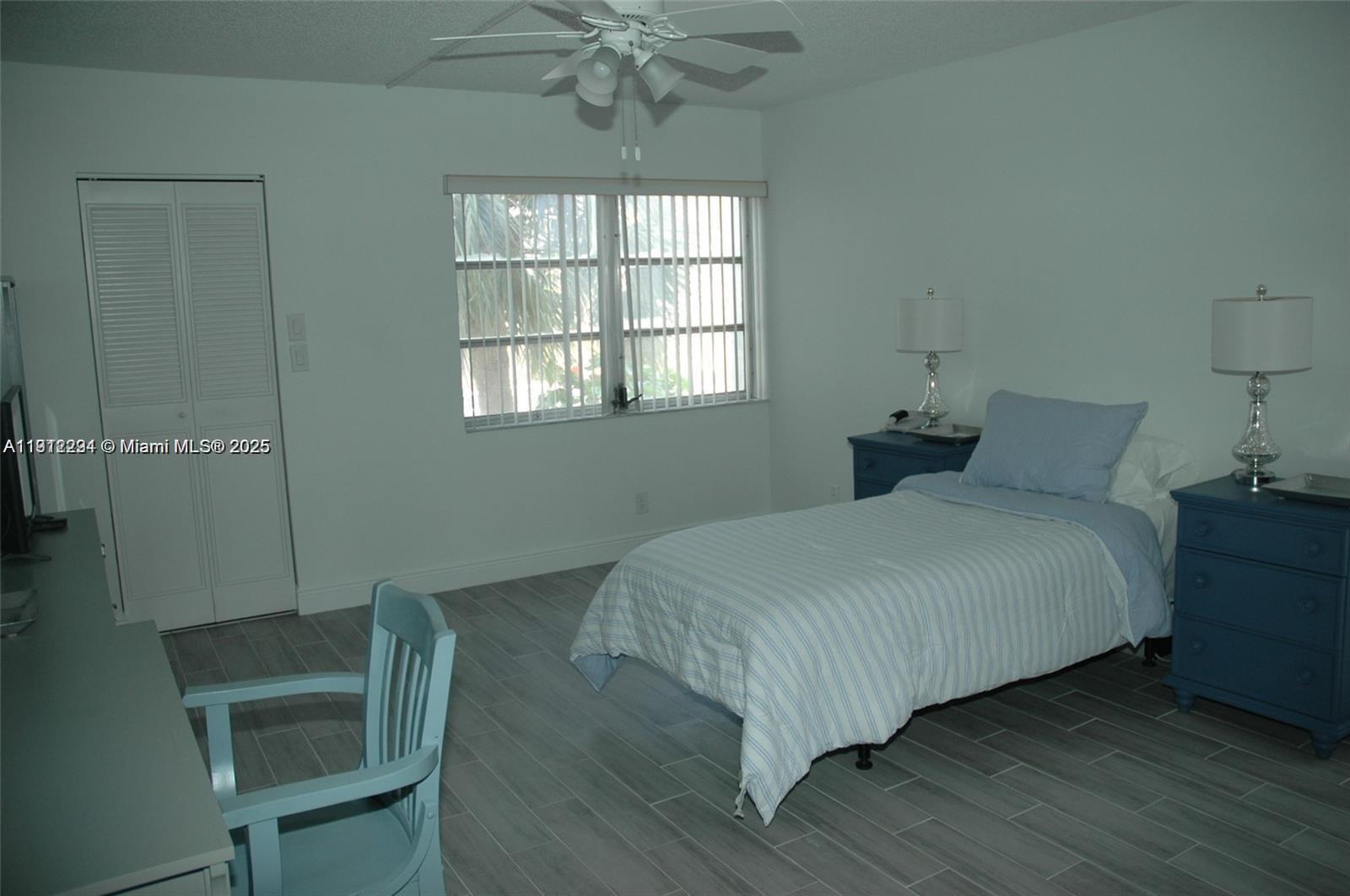 3571 Inverrary Drive, Unit 201 Lauderhill, FL 33319 - Photo 23 of 48 a bedroom with a bed and a chair