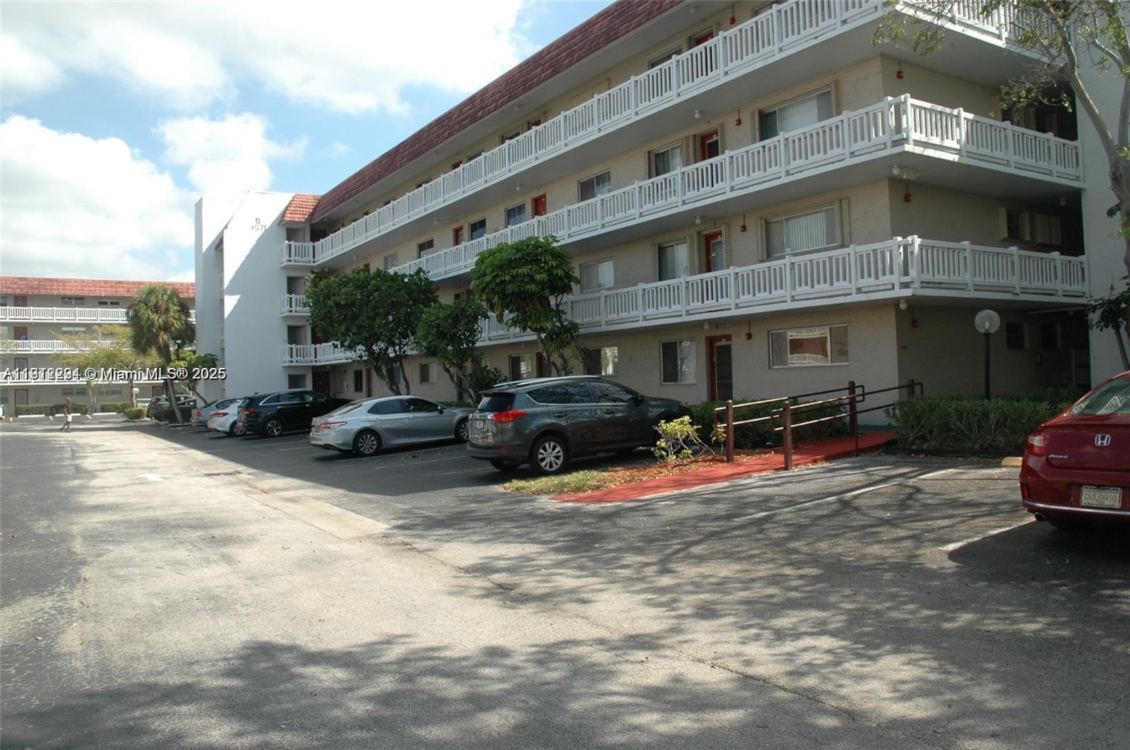 3571 Inverrary Drive, Unit 201 Lauderhill, FL 33319 - Photo 29 of 48 a car parked in front of a building