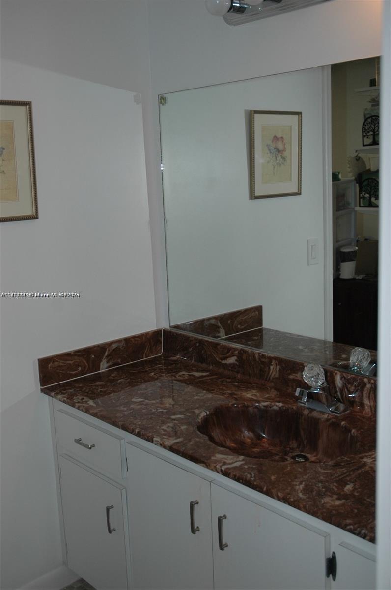 3571 Inverrary Drive, Unit 201 Lauderhill, FL 33319 - Photo 36 of 48 a bathroom with a sink and a mirror