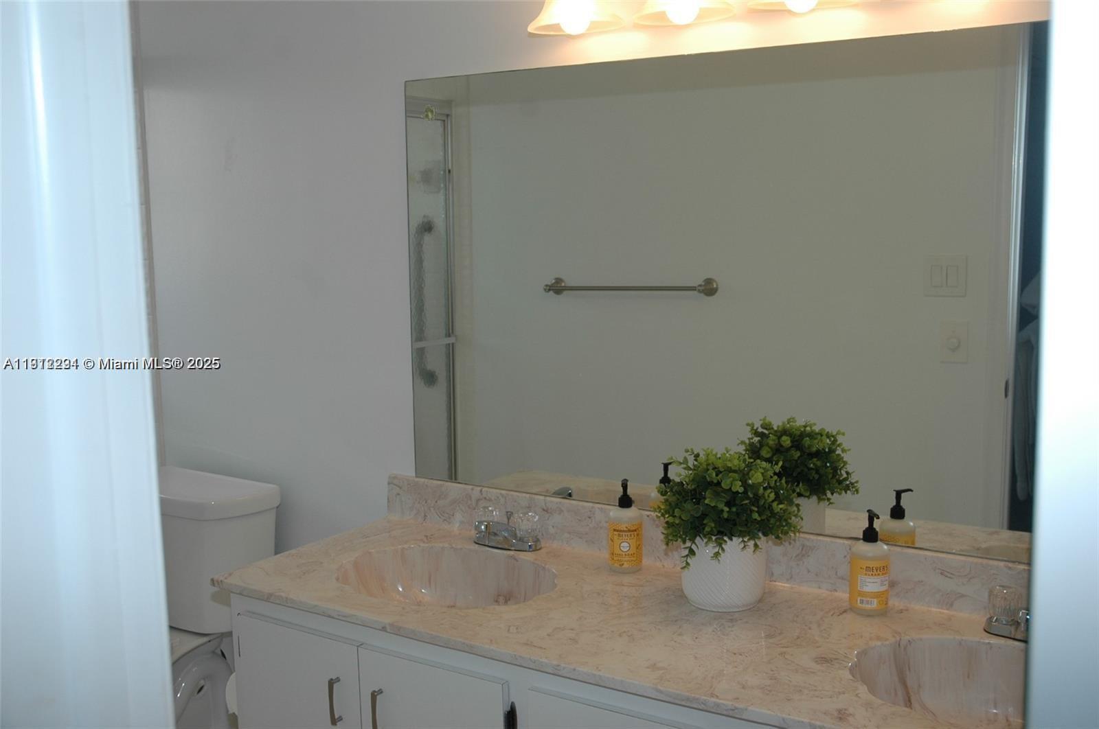 3571 Inverrary Drive, Unit 201 Lauderhill, FL 33319 - Photo 38 of 48 a bathroom with a sink a toilet and shower