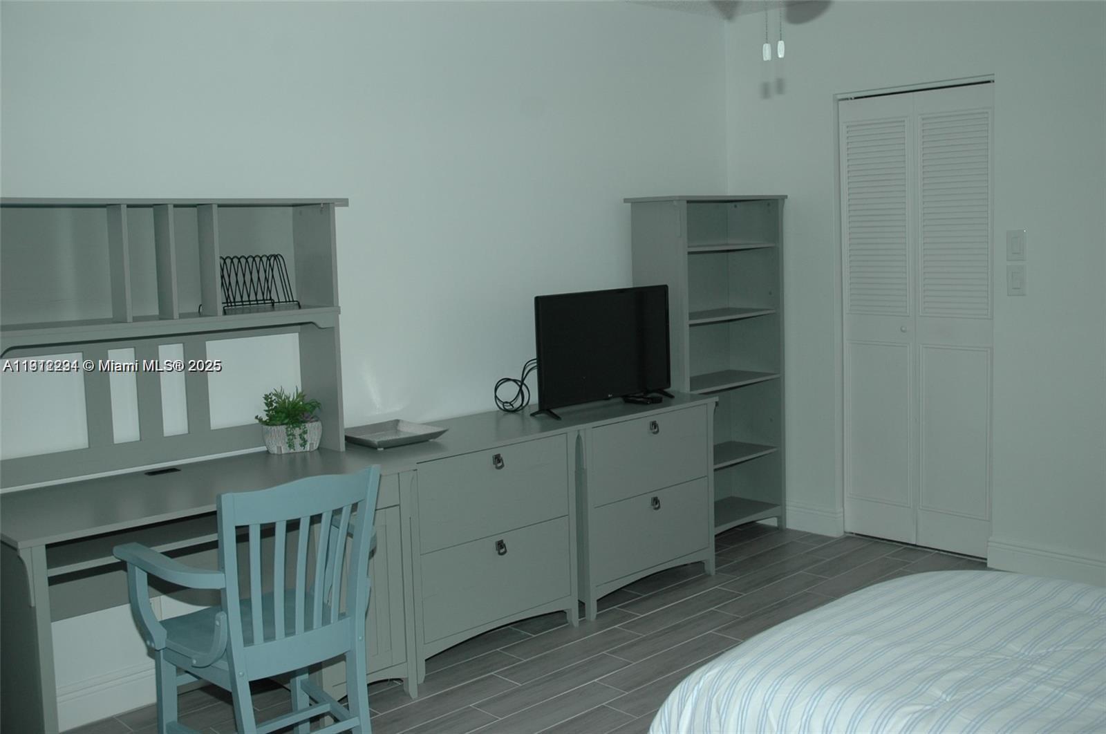 3571 Inverrary Drive, Unit 201 Lauderhill, FL 33319 - Photo 43 of 48 a bedroom with furniture and a flat screen tv