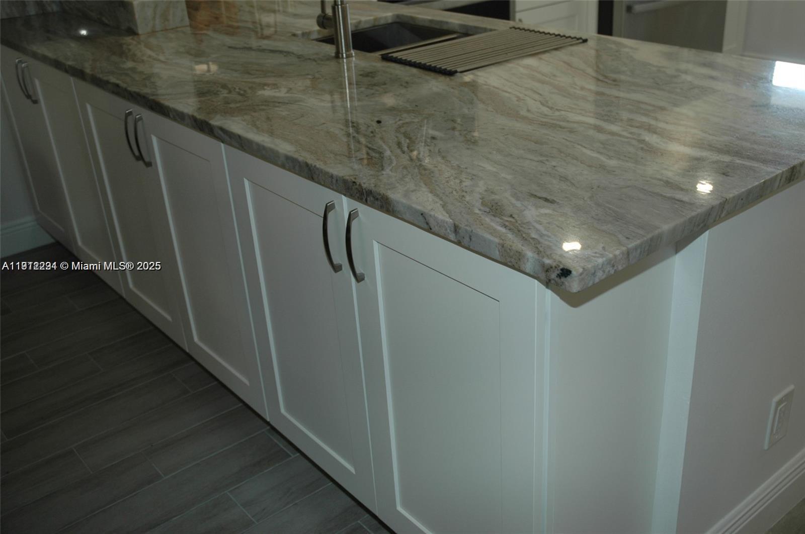 3571 Inverrary Drive, Unit 201 Lauderhill, FL 33319 - Photo 9 of 48 a hallway with sliding door and wooden floor