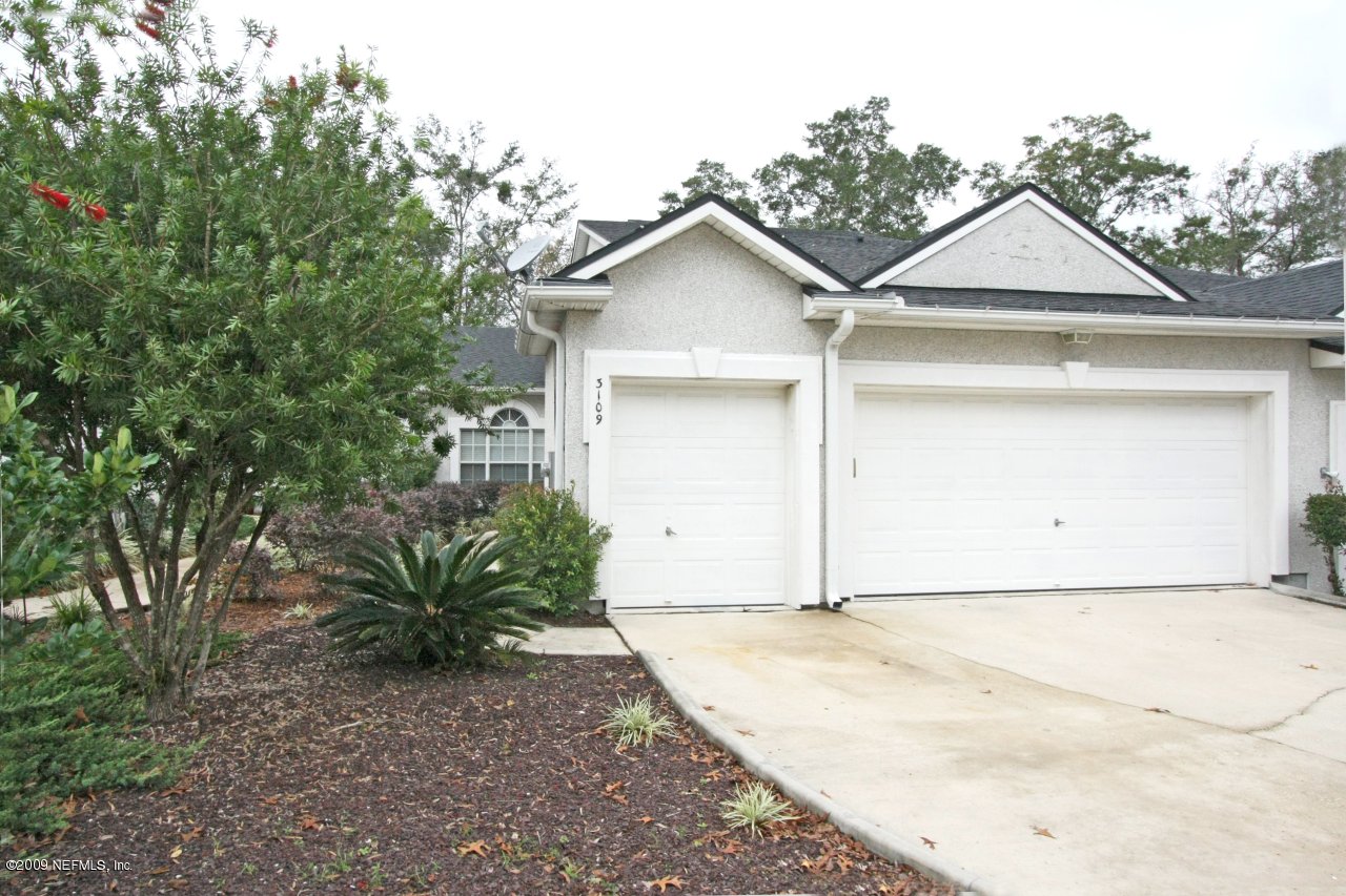 3109 Ravines Road Middleburg, FL 32068 - Photo 11 of 14 a view of a house with a yard and garage