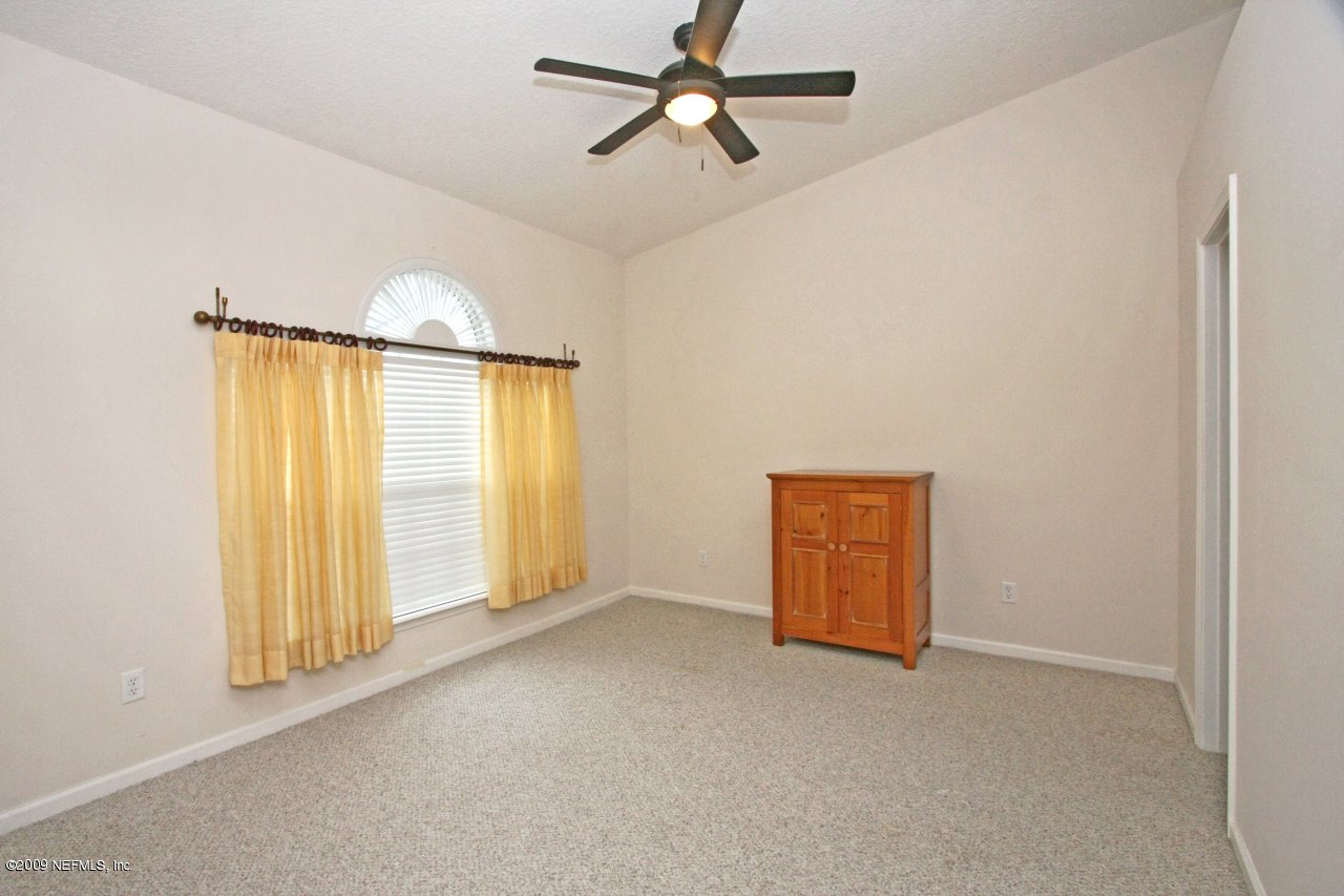 3109 Ravines Road Middleburg, FL 32068 - Photo 12 of 14 an empty room with windows and closet