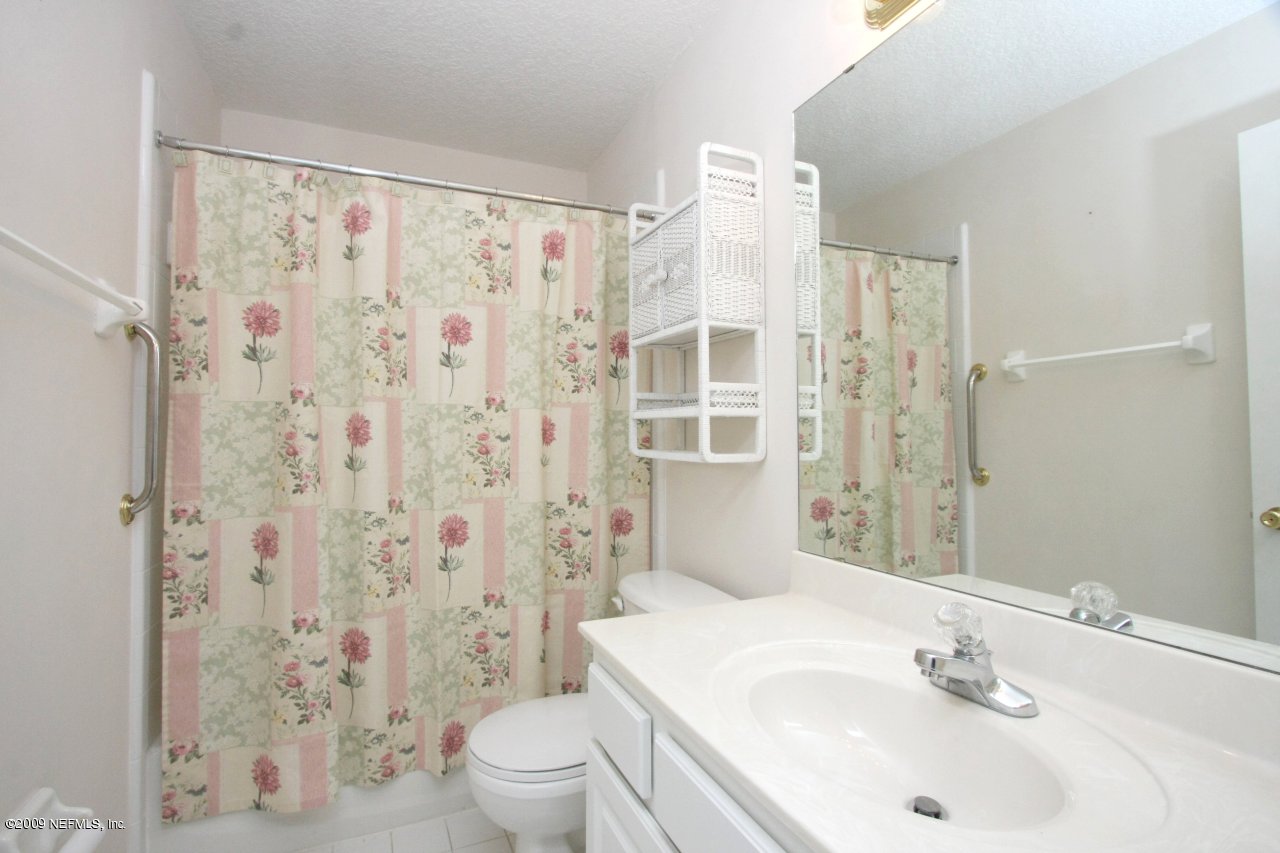 3109 Ravines Road Middleburg, FL 32068 - Photo 14 of 14 a bathroom with a sink a toilet and shower curtain