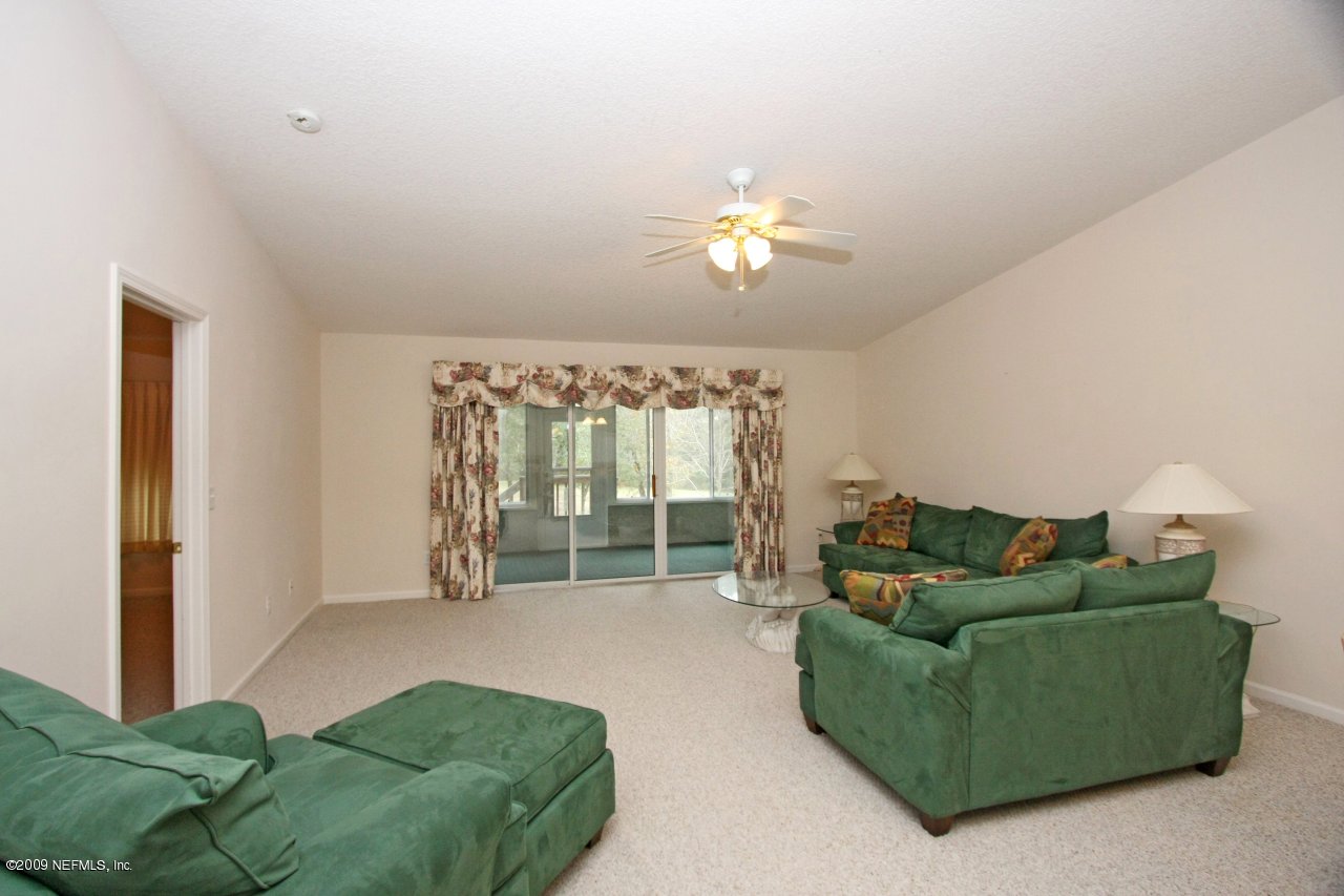 3109 Ravines Road Middleburg, FL 32068 - Photo 2 of 14 a living room with furniture and a chandelier