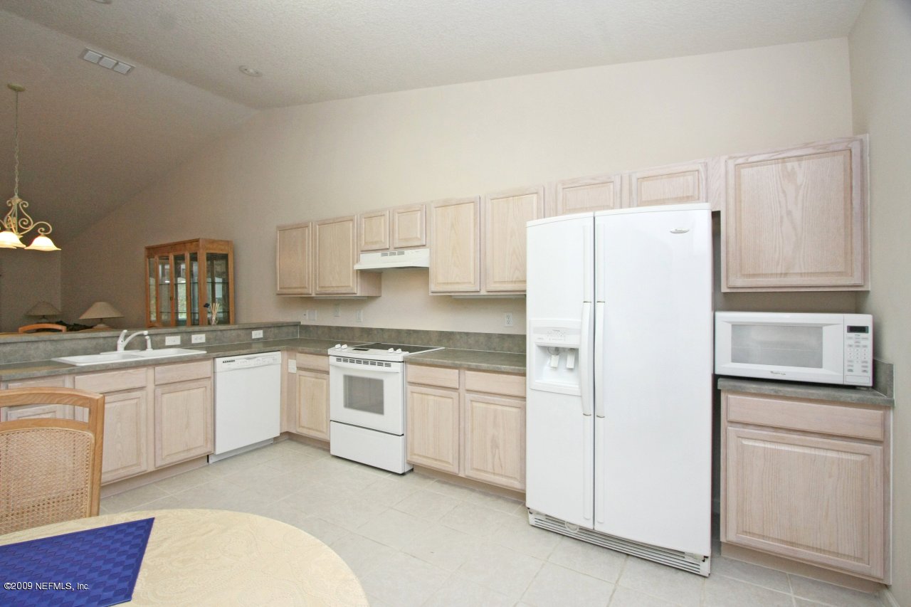 3109 Ravines Road Middleburg, FL 32068 - Photo 5 of 14 a kitchen with granite countertop cabinets and white appliances