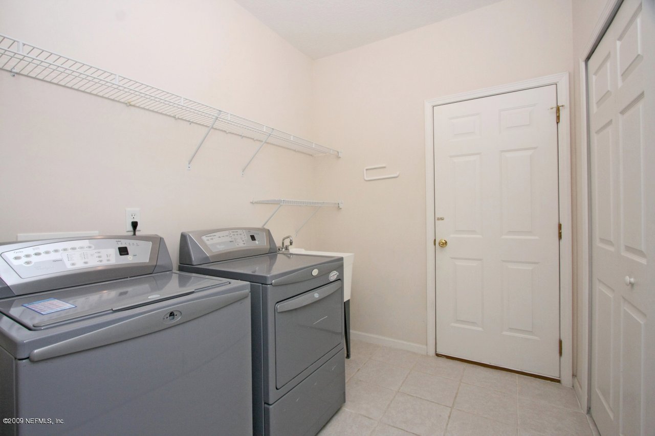 3109 Ravines Road Middleburg, FL 32068 - Photo 7 of 14 a utility room with dryer and washer