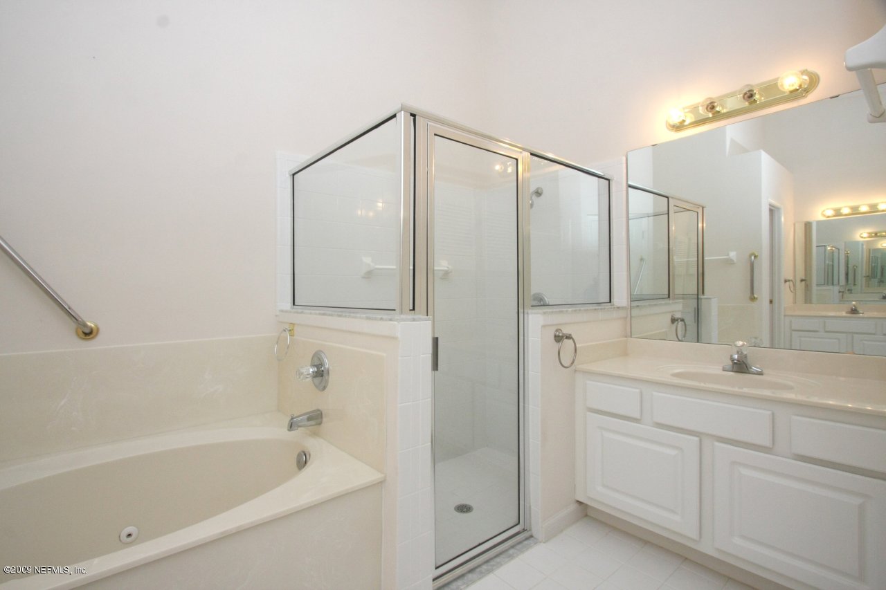3109 Ravines Road Middleburg, FL 32068 - Photo 10 of 14 a bathroom with a double vanity sink mirror and shower